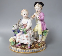 A 19th century Meissen figure group of a boy with a pipe, a girl with a grape and a goat, crossed swords in blue, incise letters and numbers. 15cm